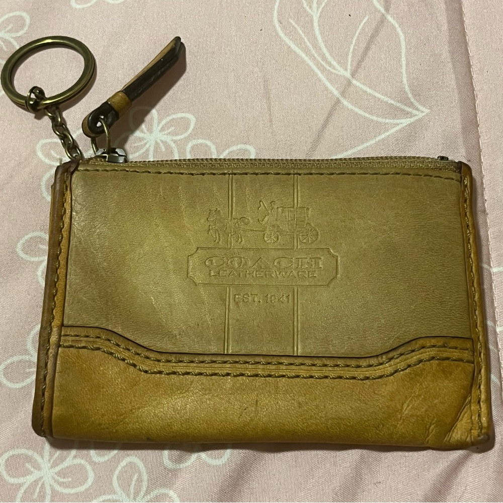 Coach coin bag in color tan. Has some wear and light staining.